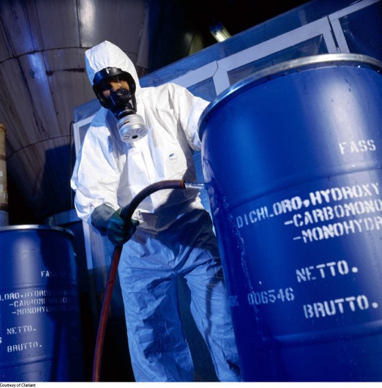 HAZWOPER certified man in hazmat suit with barrel of chemicals